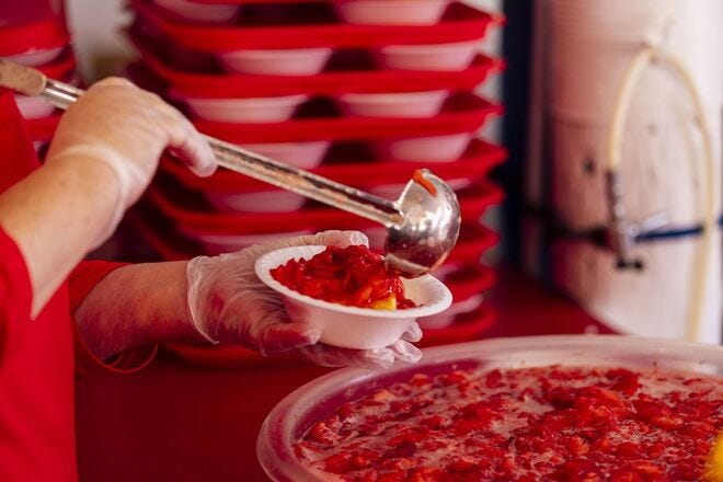 Visitors to the annual Strawberry Festival line up for fresh strawberry shortcake
